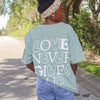 NEW! | "LOVE NEVER GIVES UP" PREMIUM COMFORT COLOR TEE | BAY