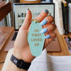 NEW! | "HE FIRST LOVED US" | KEYCHAIN | MINT